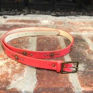 Women’s 3/4” wide coral belt with burnished gold tone and silver tone studs. 36”